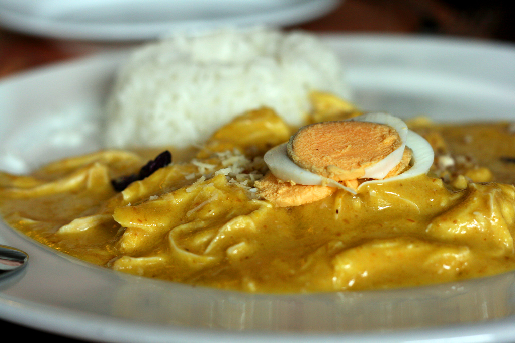 Aji de Gallina - Traditional Peruvian Creole Dish from Lima, Peru, based on shredded hen in a creamy yellow chili pepper sauce.